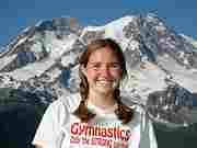 Angela Cranney posing in front of Mt. Rainier.