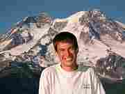 Derek Rowley posing in front of Mt. Rainier.